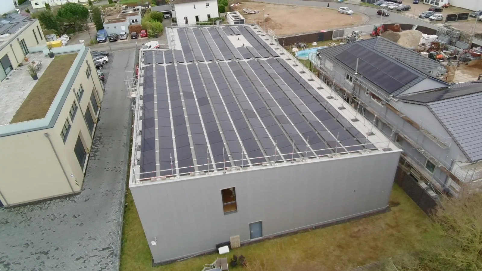 Flachdach eines Gewerbegebäudes mit Photovoltaikanlage aus der Luft